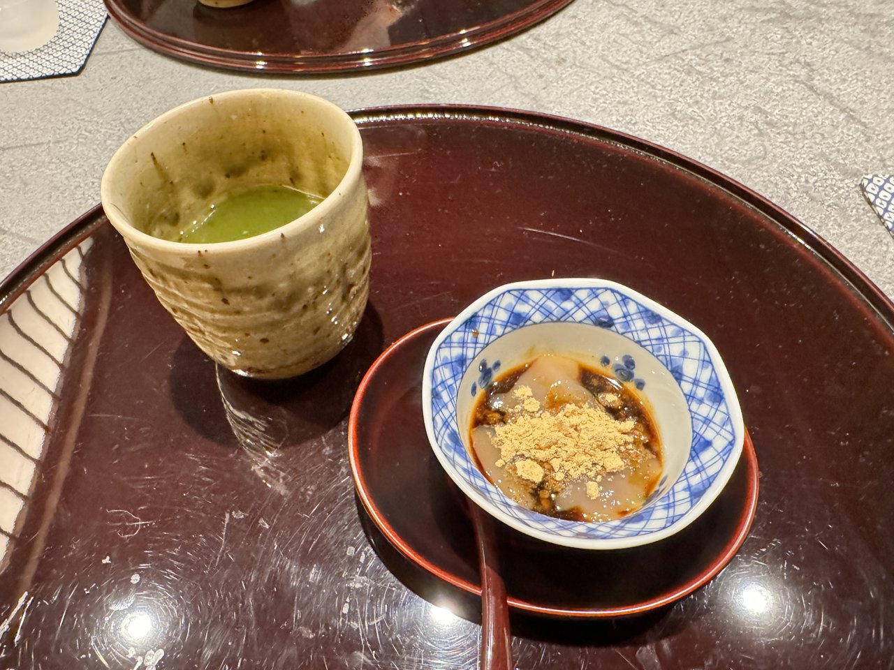染付の小鉢に入った黒蜜ときな粉のわらび餅のような甘味と、焼き物の器の抹茶